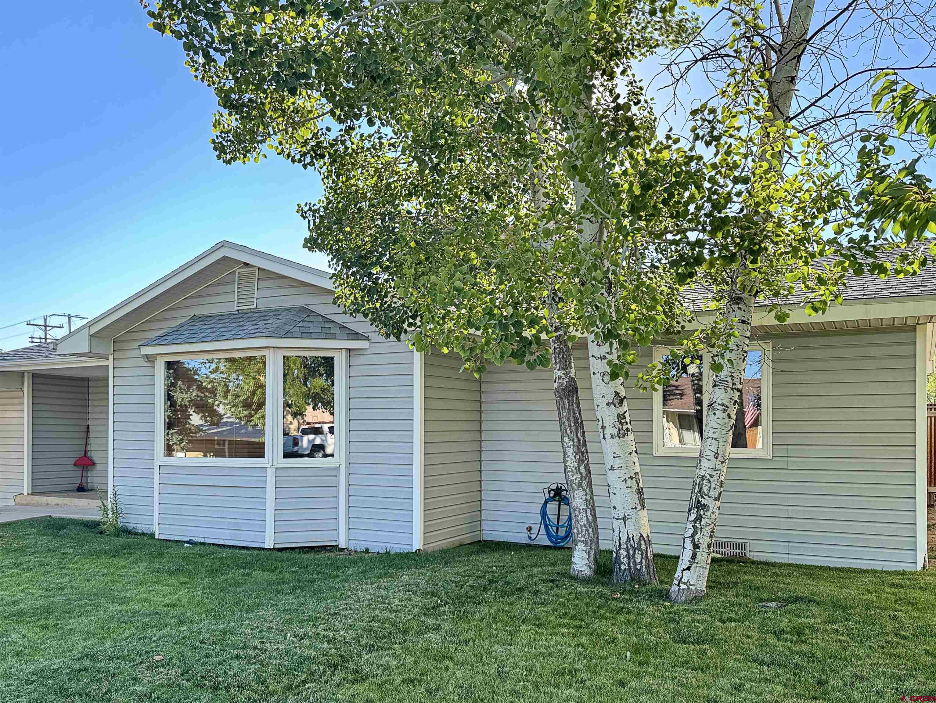 219 Edith Street Cortez, CO 81321 - Photo 4 of 29 a front view of house with yard and green space