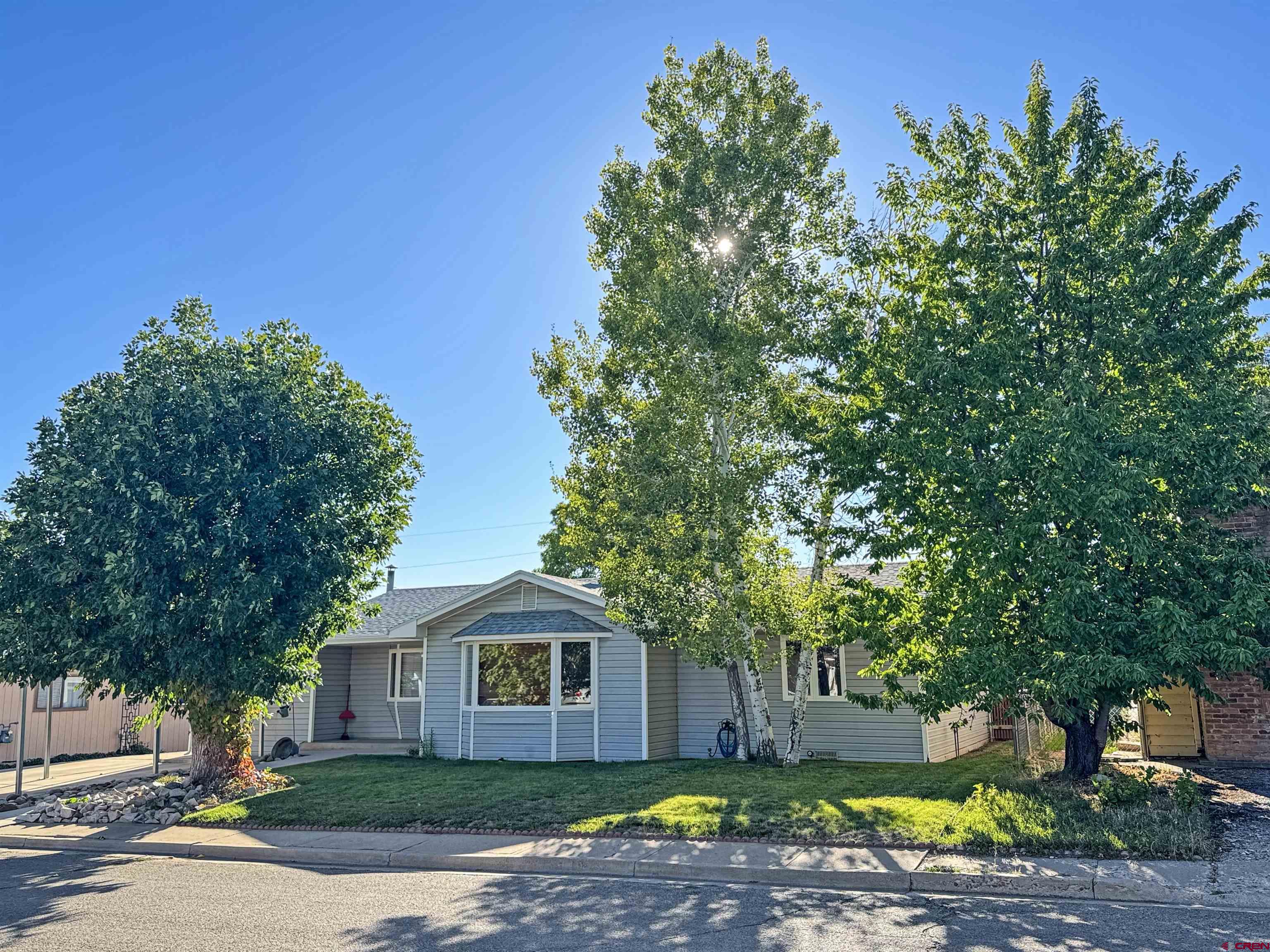 219 Edith Street Cortez, CO 81321 - Photo 5 of 29 a front view of a house with a garden
