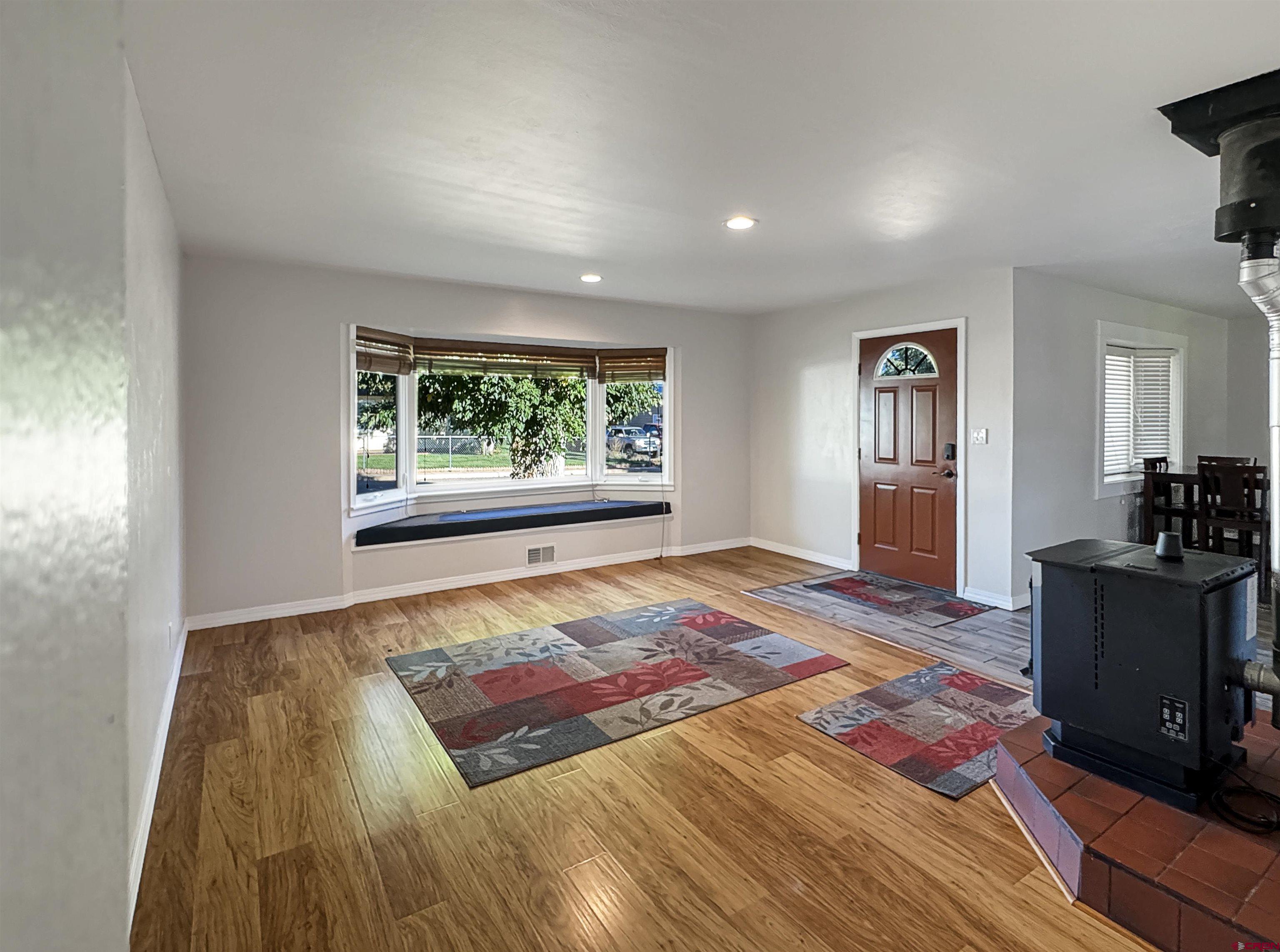 219 Edith Street Cortez, CO 81321 - Photo 7 of 29 a bedroom with a bed and a dresser next to a window