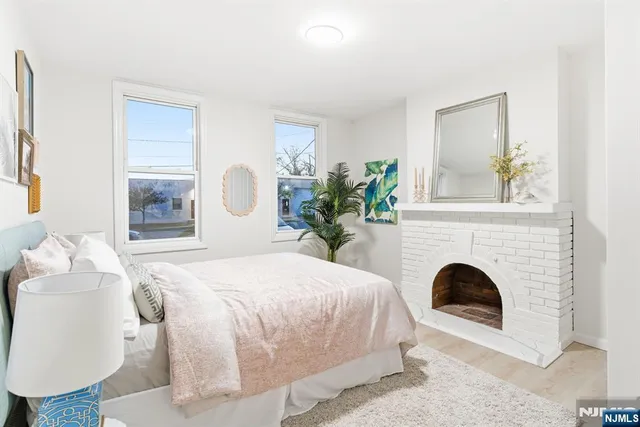 a bedroom with a bed and a fireplace