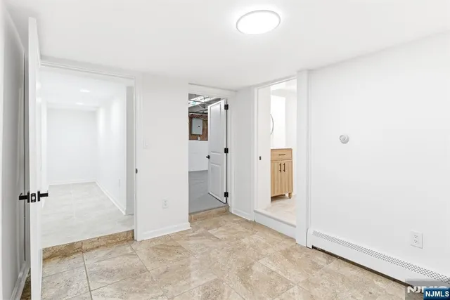 an empty room with windows and closet