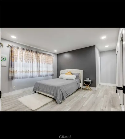 a bedroom with a large bed and a large window