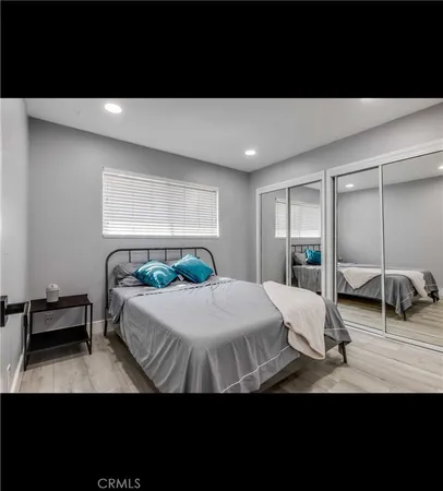 a bedroom with a bed and large mirror