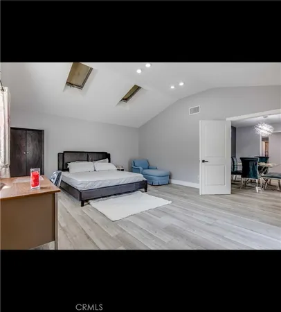 a view of kitchen with stainless steel appliances a sink dishwasher and wooden floor