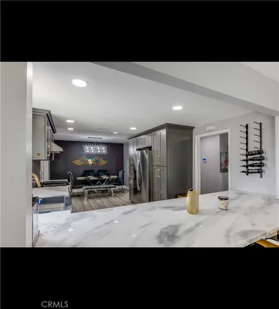 a view of kitchen with stainless steel appliances a sink and stove