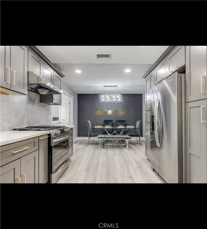 a view of kitchen with sink stove and refrigerator