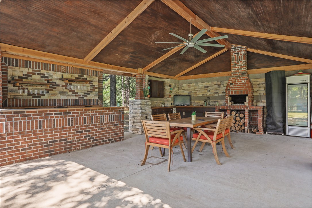 694 Overstreet Road Jesup, GA 31546 - Photo 5 of 23 Outdoor Kitchen, with bar, sing, grill, chimney, and fridge.