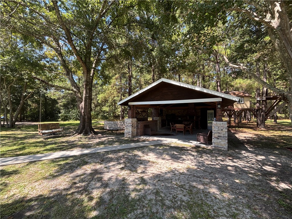 694 Overstreet Road Jesup, GA 31546 - Photo 5 of 23 Outdoor Kitchen and Fire Pit Area