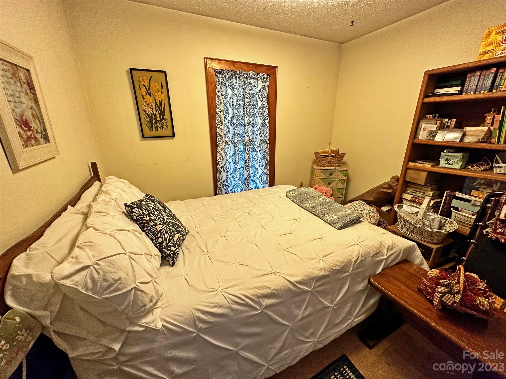 1151 Carpenters Grove Church Road Lawndale, NC 28090 - Photo 24 of 46 a bedroom with a bed and a painting on the wall