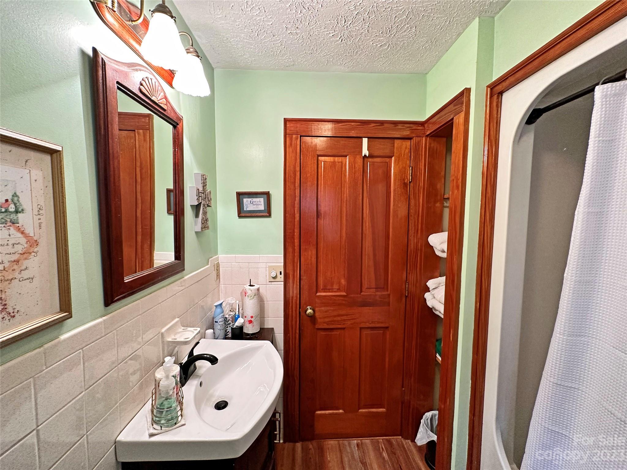 1151 Carpenters Grove Church Road Lawndale, NC 28090 - Photo 27 of 46 a bathroom with a sink a mirror and a window