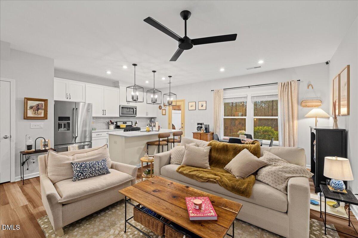 845 Oak Center Drive Raleigh, NC 27610 - Photo 10 of 29 a living room with furniture and a large window