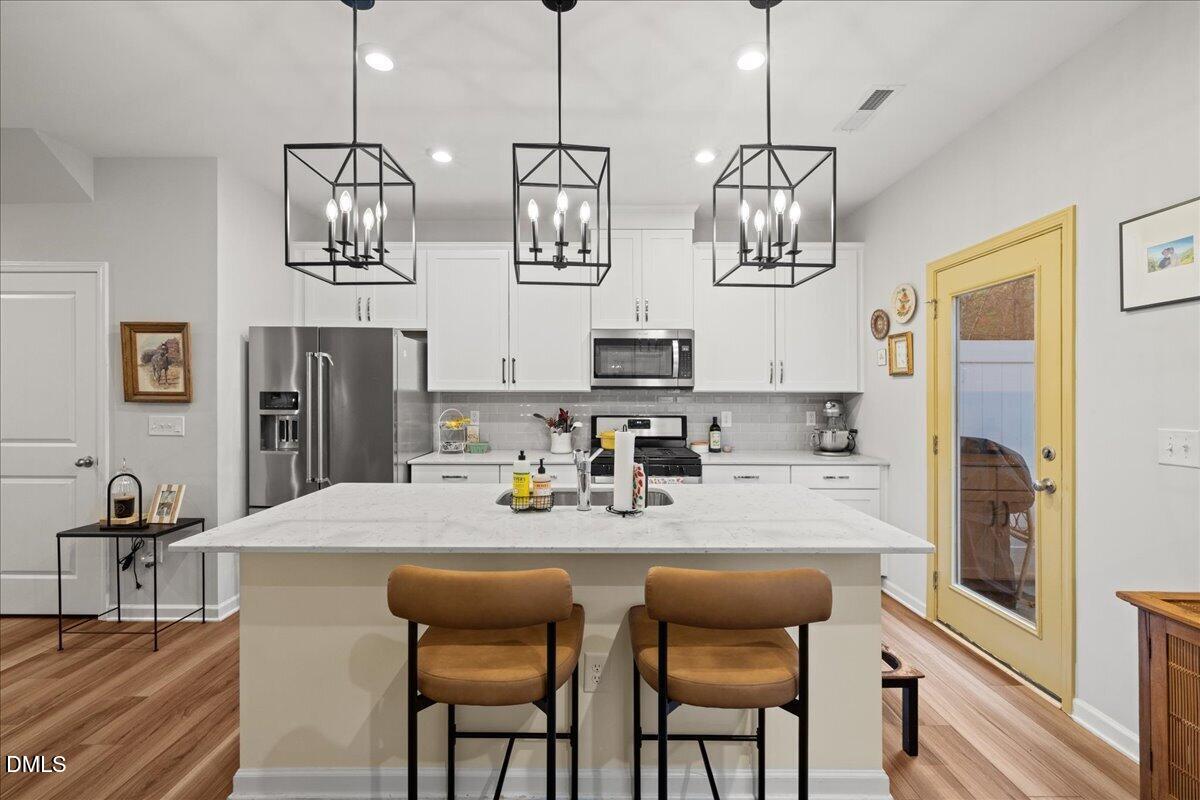 845 Oak Center Drive Raleigh, NC 27610 - Photo 11 of 29 a kitchen with stainless steel appliances granite countertop a sink and a refrigerator