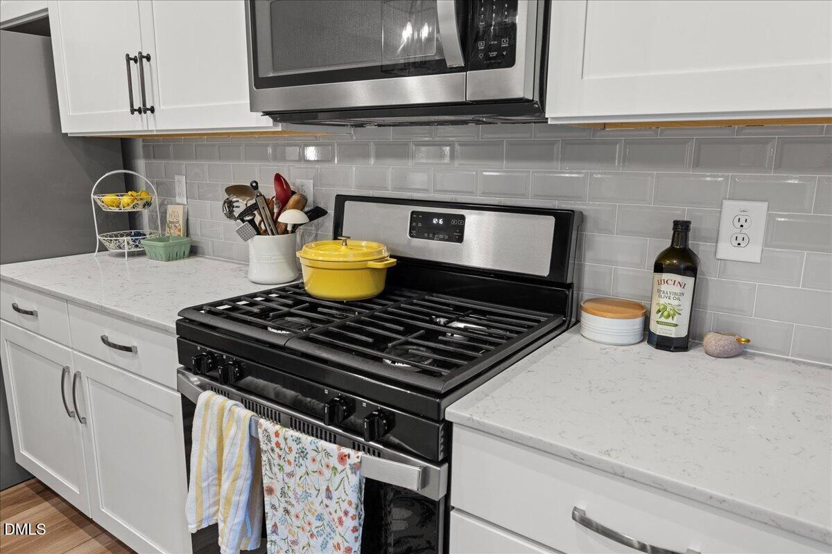 845 Oak Center Drive Raleigh, NC 27610 - Photo 12 of 29 a stove top oven sitting inside of a kitchen