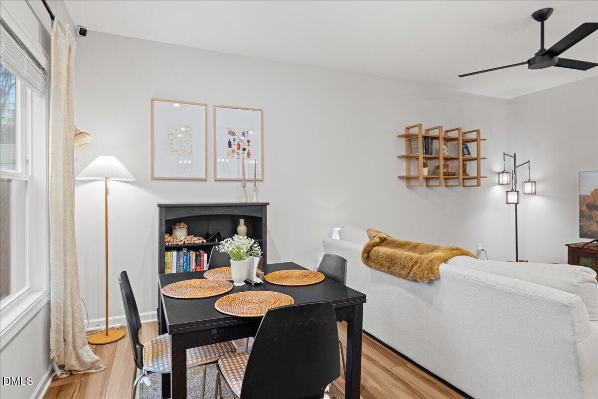 845 Oak Center Drive Raleigh, NC 27610 - Photo 13 of 29 a living room with furniture and a dining table with wooden floor