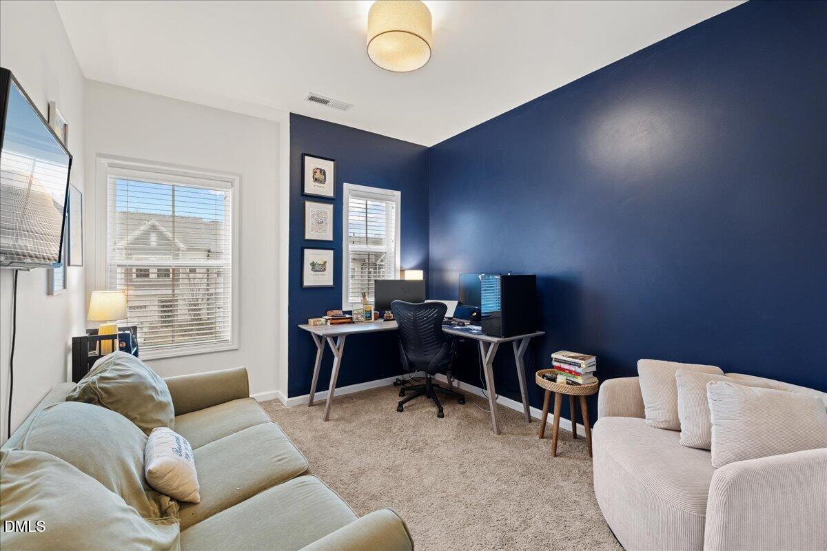 845 Oak Center Drive Raleigh, NC 27610 - Photo 18 of 29 a living room with furniture and a flat screen tv