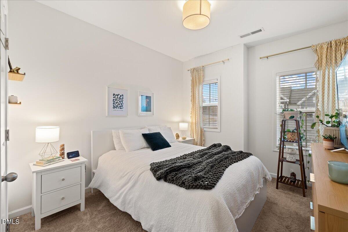 845 Oak Center Drive Raleigh, NC 27610 - Photo 20 of 29 a bedroom with a bed and wooden floor