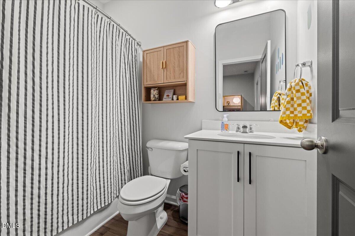 845 Oak Center Drive Raleigh, NC 27610 - Photo 22 of 29 a bathroom with a sink toilet and mirror