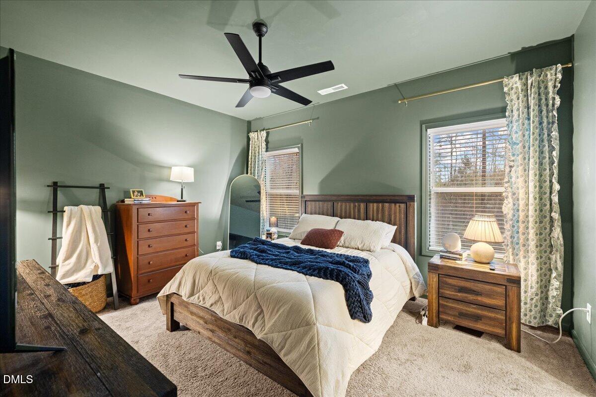 845 Oak Center Drive Raleigh, NC 27610 - Photo 24 of 29 a bedroom with a bed a chandelier and dresser