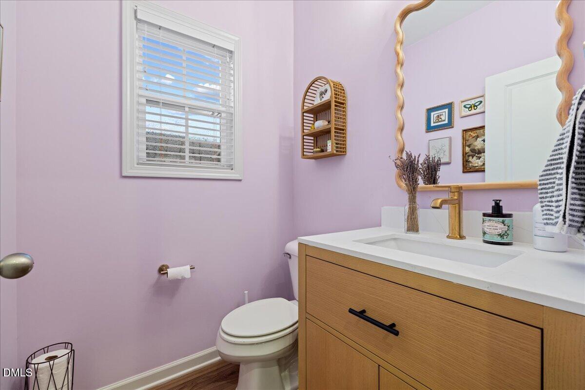 845 Oak Center Drive Raleigh, NC 27610 - Photo 4 of 29 a bathroom with a granite countertop toilet sink and mirror