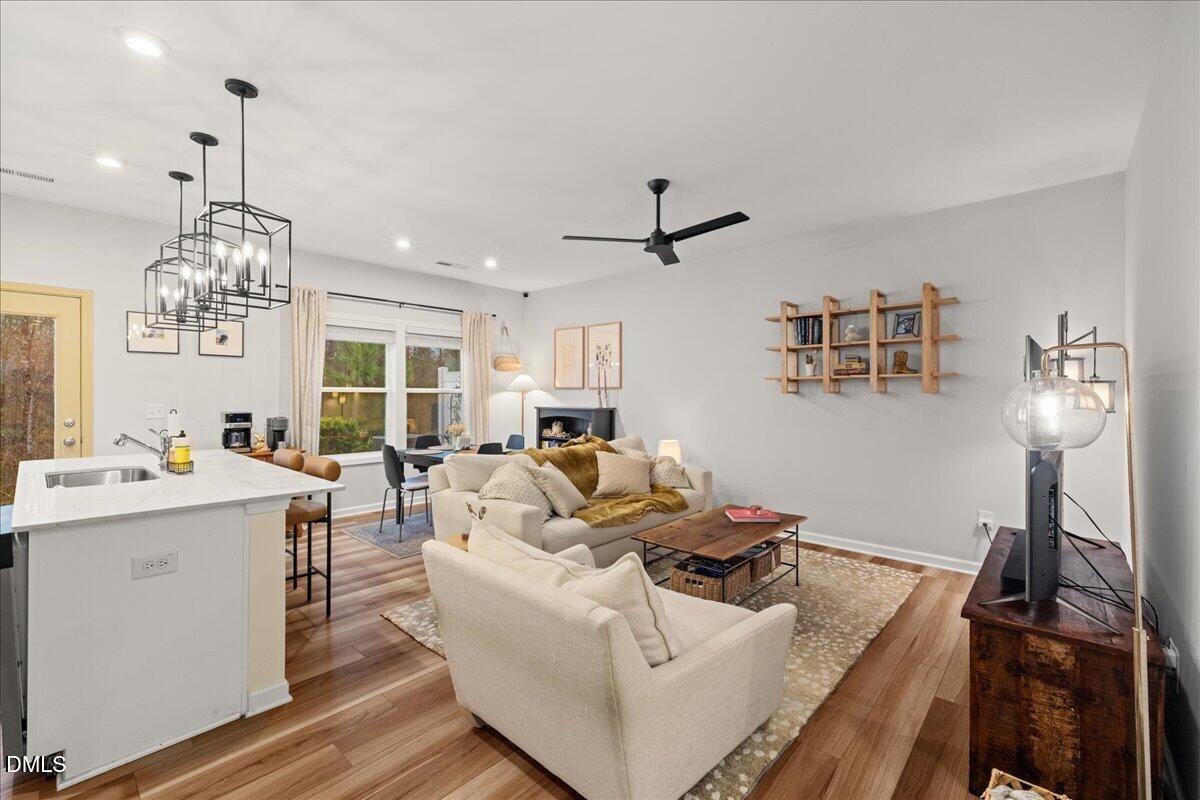 845 Oak Center Drive Raleigh, NC 27610 - Photo 8 of 29 a living room with furniture and chandelier