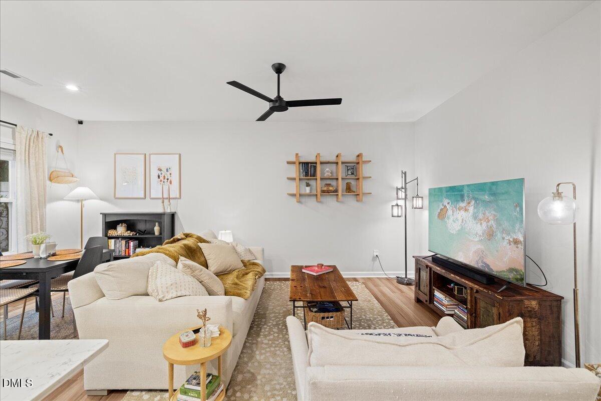 845 Oak Center Drive Raleigh, NC 27610 - Photo 9 of 29 a living room with furniture and a flat screen tv
