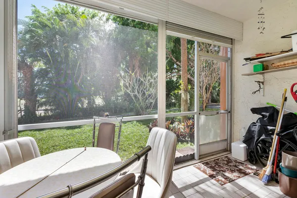 a view of a porch with furniture and garden