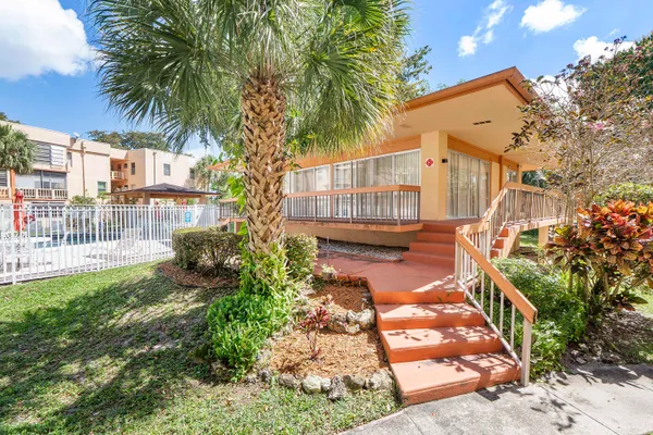 an aerial view of a city with lots of residential buildings ocean and mountain view in back
