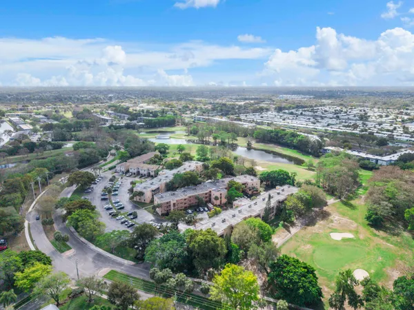 an aerial view of residential houses with outdoor space and trees