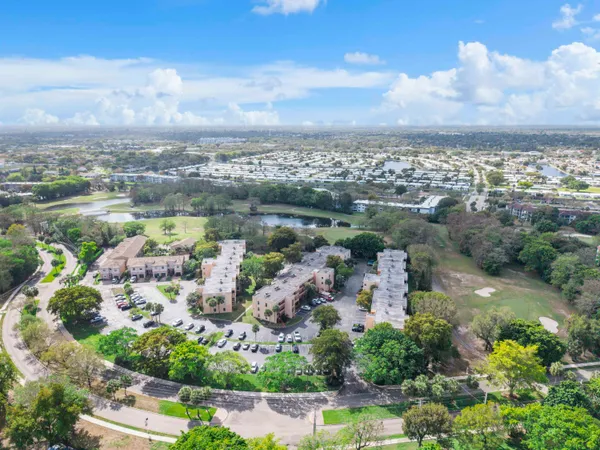 an aerial view of residential houses with outdoor space and trees