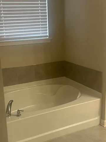 a bath tub sitting next to a window