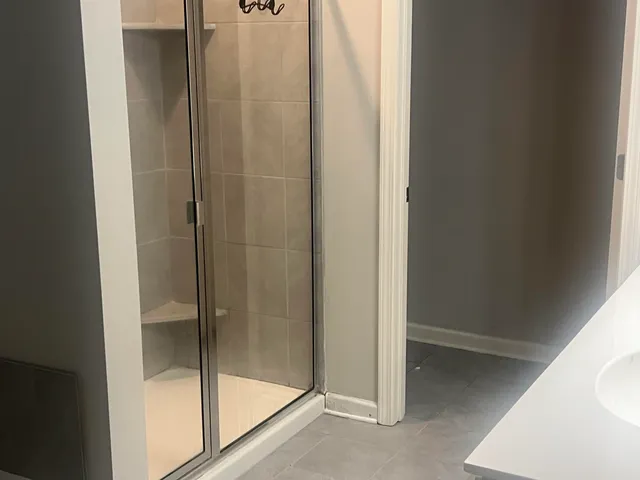 a bathroom with a glass shower door