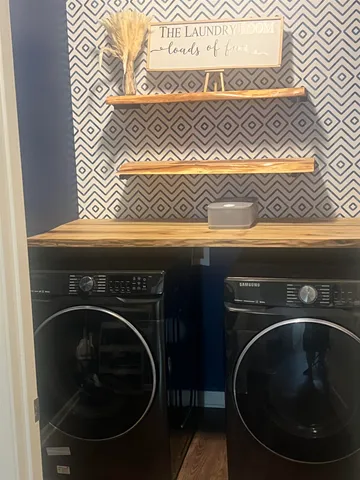 a utility room with a sink and wooden floor