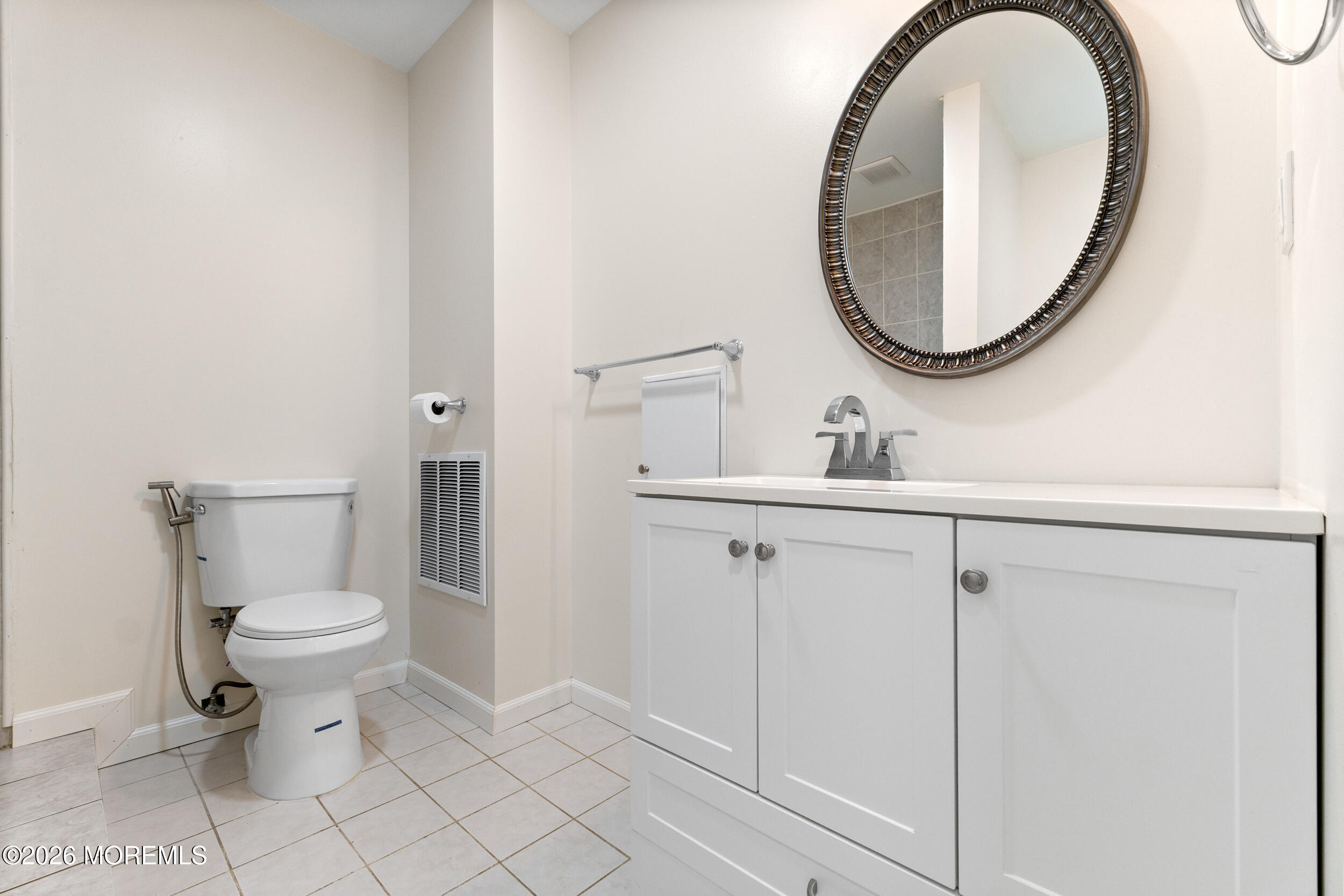 104 Autumn Road Matawan, NJ 07747 - Photo 48 of 64 a bathroom with a sink mirror and a toilet