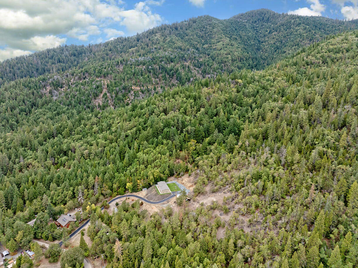 5572 Jumpoff Joe Creek Road Grants Pass, OR 97526 - Photo 28 of 38 a view of a forest with a street
