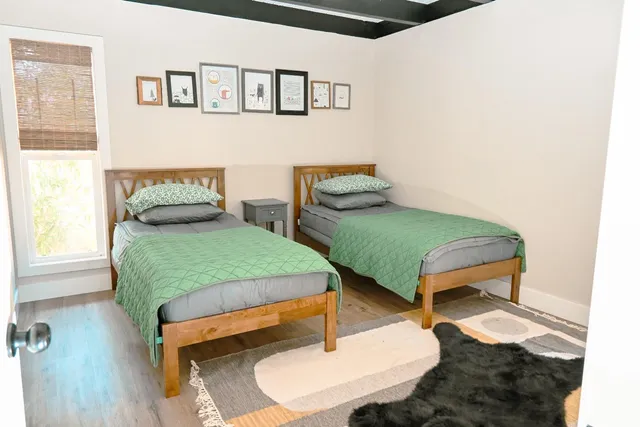 a bedroom with a bed and wooden floor