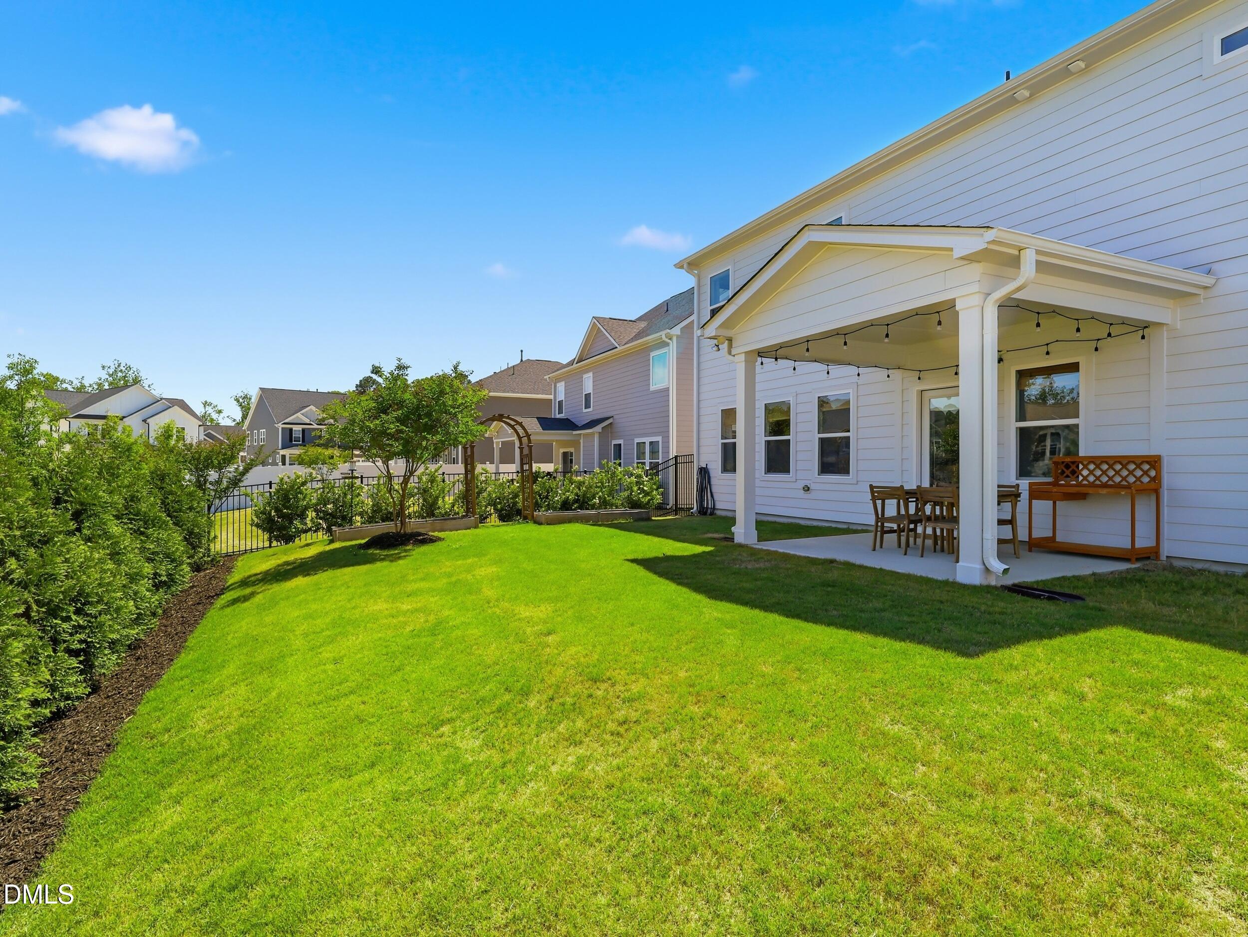 2709 Womble Ridge Drive New Hill, NC 27562 - Photo 47 of 60 a view of a house with a backyard porch and sitting area