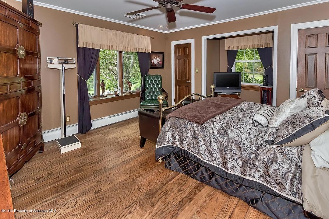 368 Maple Lake Road Moscow, PA 18444 - Photo 27 of 51 a bed sitting in a spacious bedroom next to a window