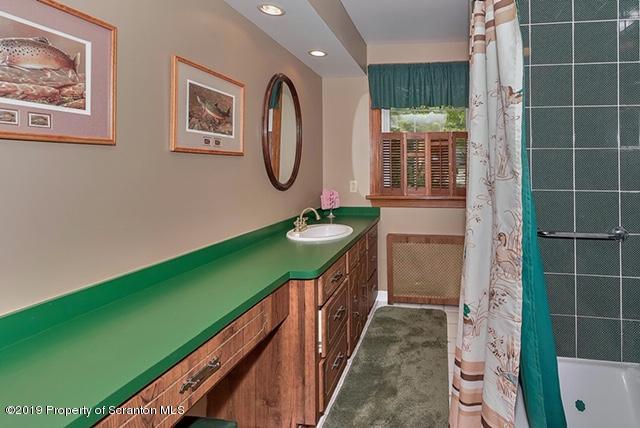 368 Maple Lake Road Moscow, PA 18444 - Photo 28 of 51 a bathroom with a sink a mirror and a shower