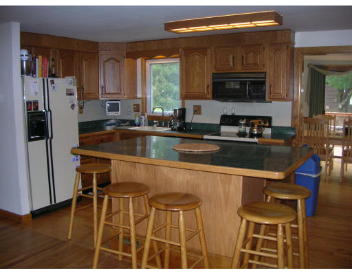 9 Walsh Road Holbrook, MA 02343 - Photo 10 of 19 a kitchen with stainless steel appliances kitchen island granite countertop a refrigerator a stove top oven and a sink