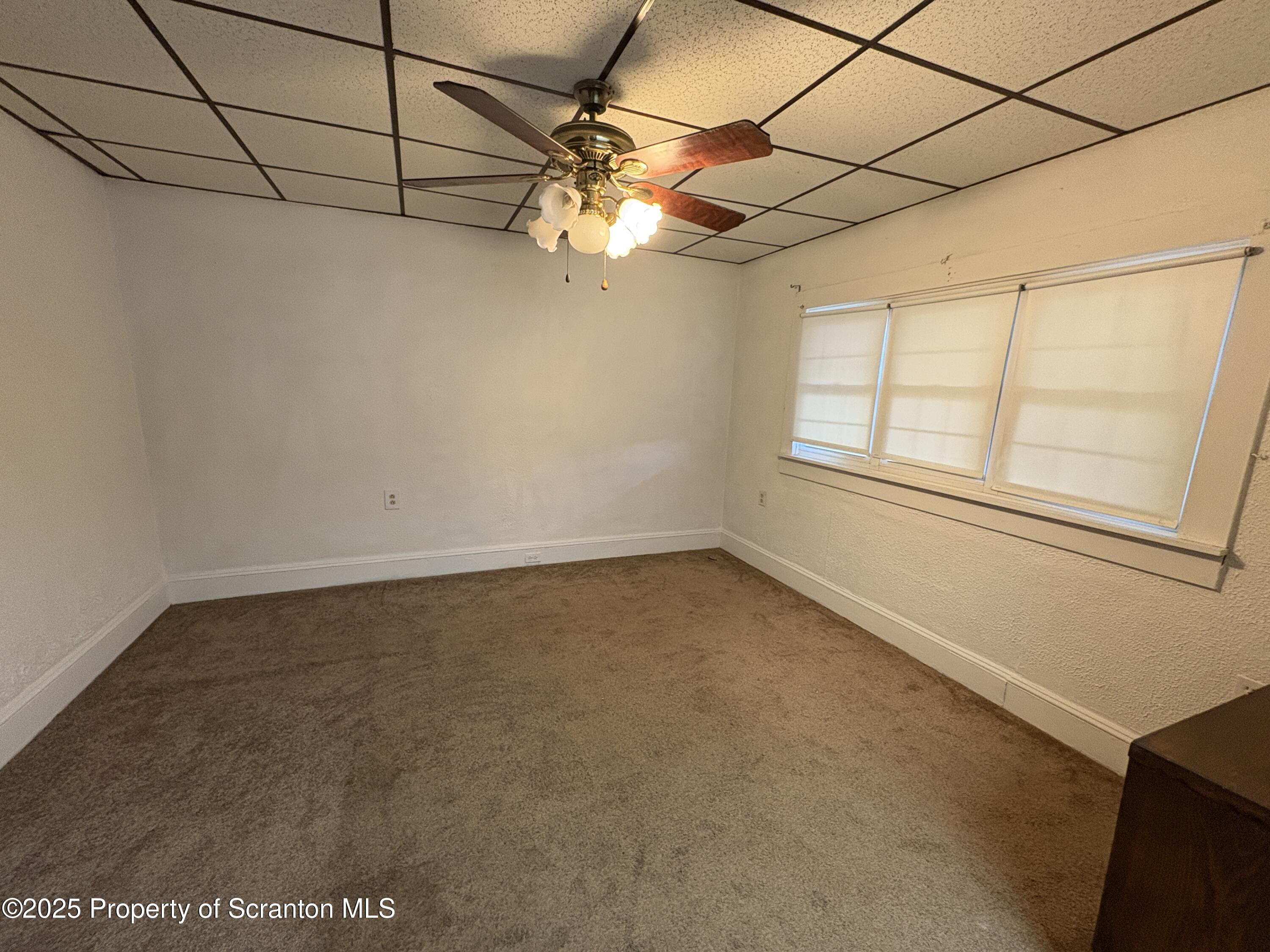 1819 Clearview Street, Unit L 109 Scranton, PA 18504 - Photo 7 of 23 an empty room with a windows and ceiling fan