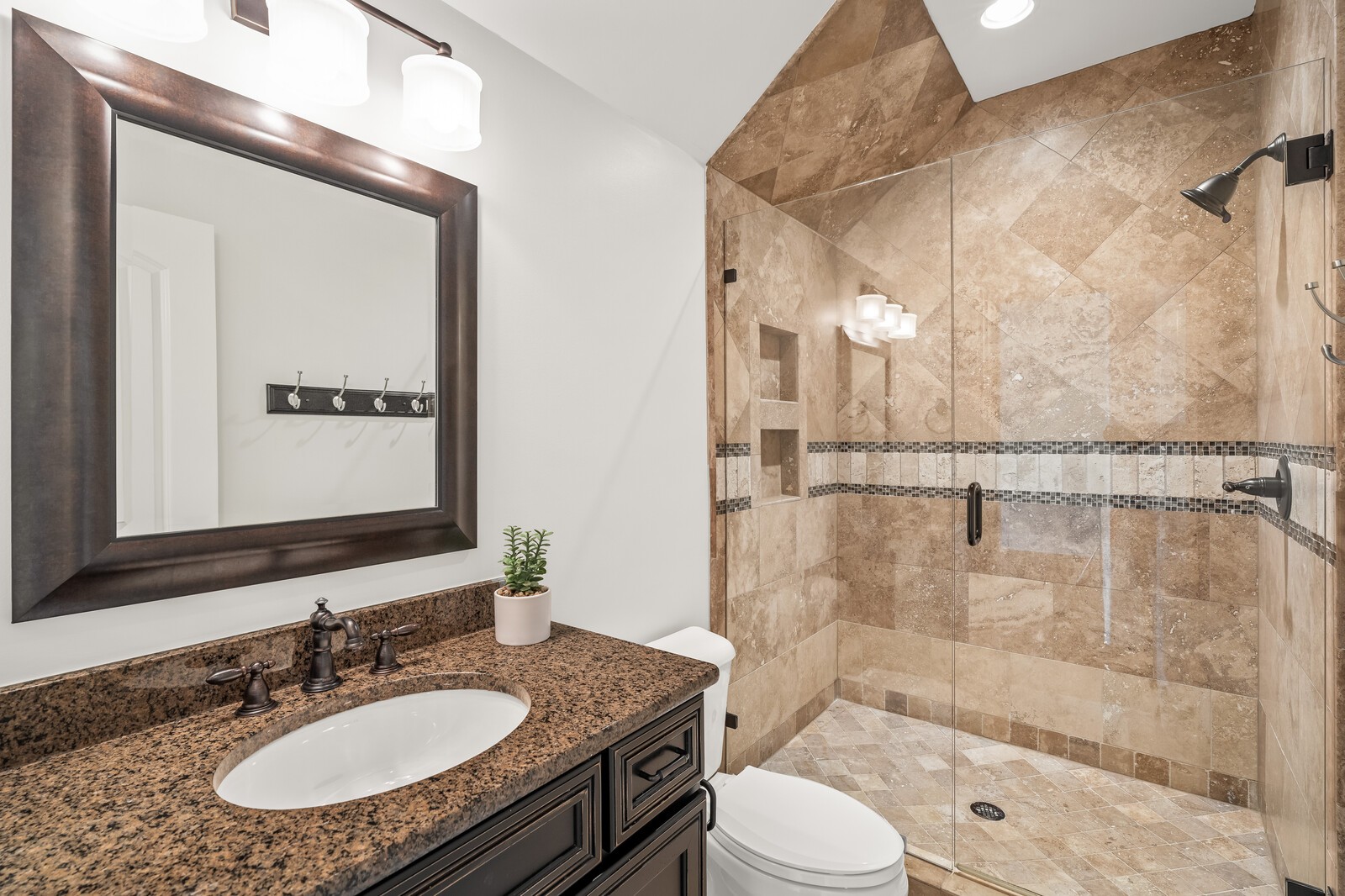 926 Evans Road Nashville, TN 37204 - Photo 42 of 53 a bathroom with a granite countertop sink toilet a mirror and shower