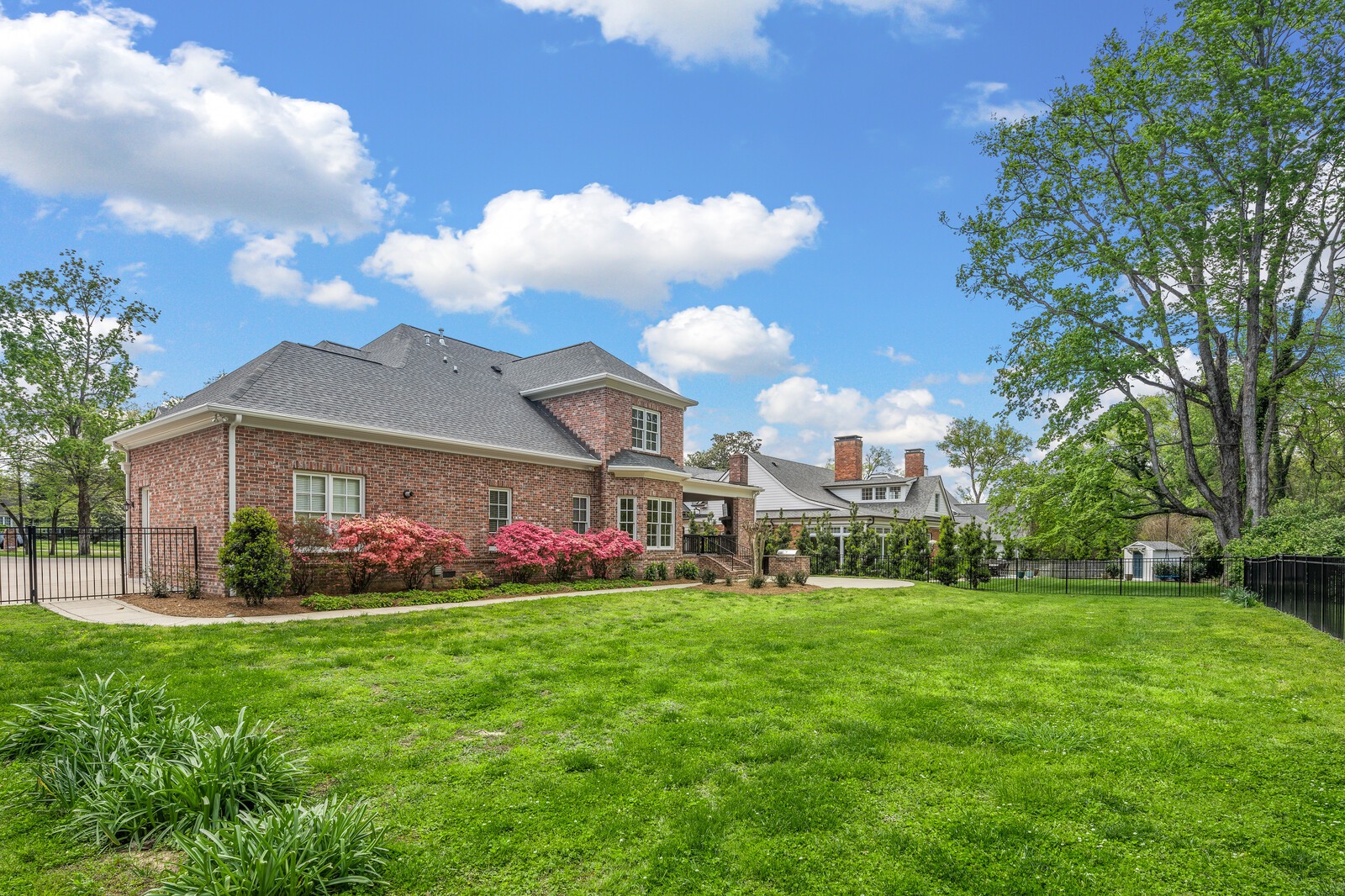 926 Evans Road Nashville, TN 37204 - Photo 52 of 53 a view of a white house with a big yard and large trees
