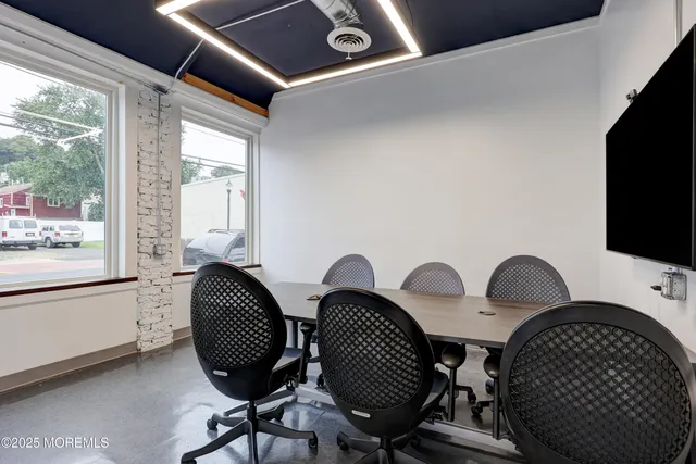 a view of workspace with wooden floor windows