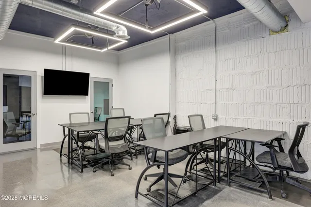 a view of a dining room with furniture and a flat screen tv