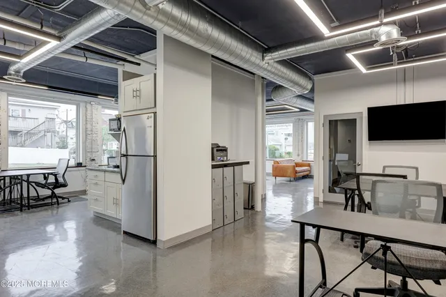 a kitchen with stainless steel appliances wooden floor dining table and chairs