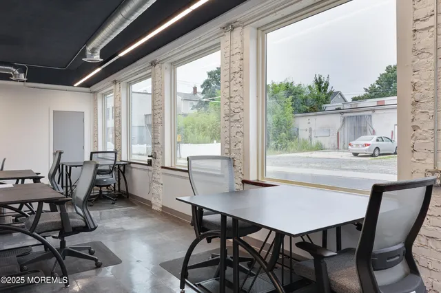 a dining room with furniture and wooden floor