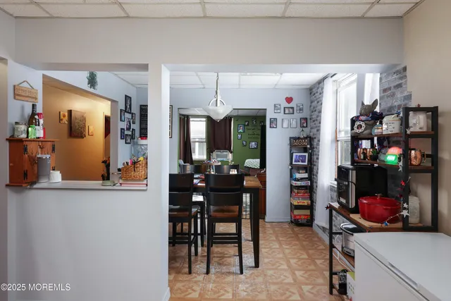 a view of a dining room with furniture and chandelier