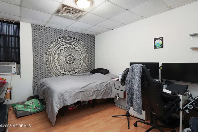 a bedroom with bed and wooden floor