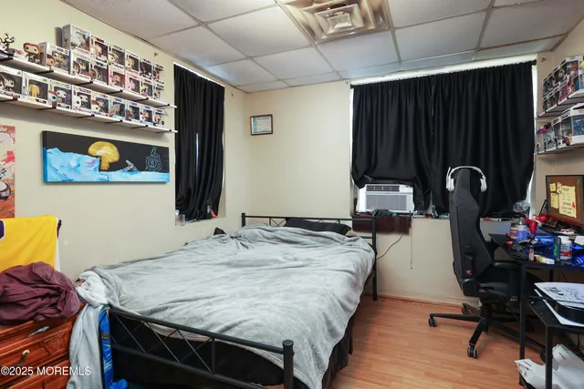 a bedroom with a bed and a dresser in it