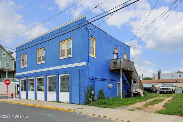 a view of a brick house with a yard next to a road